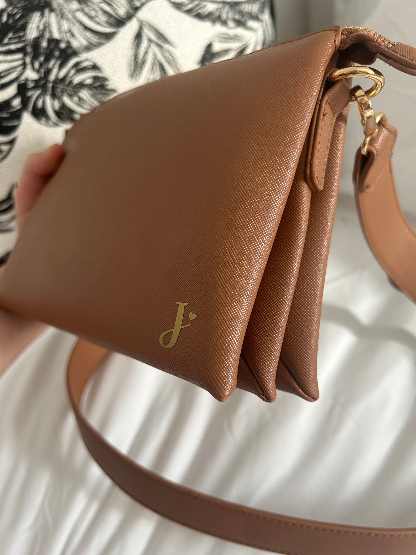 Monogrammed cross body bag.